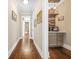 Hallway leading to a bar area, featuring hardwood floors and neutral wall colors at 6585 Queen Mill Se Rd, Mableton, GA 30126