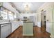 White kitchen with island, stainless steel appliances, and hardwood floors at 6585 Queen Mill Se Rd, Mableton, GA 30126