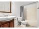 Clean bathroom with a tub, toilet, and vanity with a wood cabinet at 663 Frasier Se Cir, Marietta, GA 30060