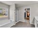 Bathroom with soaking tub, shower, and access to a walk-in closet at 210 Omega Ct, Dallas, GA 30157