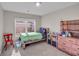 Bedroom with twin-size bed, built-in shelving, and lots of natural light at 210 Omega Ct, Dallas, GA 30157
