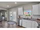Kitchen features white cabinets, granite countertops, stainless steel appliances, and French doors at 210 Omega Ct, Dallas, GA 30157