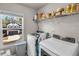 Laundry room with washer, dryer, and overhead storage at 210 Omega Ct, Dallas, GA 30157