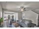 Open living room with kitchen view, neutral colors, and ceiling fan at 210 Omega Ct, Dallas, GA 30157