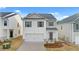 Two-story house with white siding, gray accents, and a two-car garage at 12029 Conrad Circle, Hampton, GA 30228