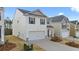 Two-story house with white siding, gray accents, and a two-car garage at 12029 Conrad Circle, Hampton, GA 30228