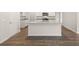Modern kitchen with granite countertops, island, and dark hardwood floors at 12029 Conrad Circle, Hampton, GA 30228
