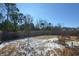 Large backyard with a fenced perimeter and some patchy snow at 129 Warbler Way, Mcdonough, GA 30253