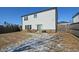 Large backyard with a fenced perimeter and some patchy snow at 129 Warbler Way, Mcdonough, GA 30253