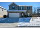 Two-story brick home with a white garage door and landscaping at 129 Warbler Way, Mcdonough, GA 30253