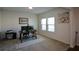 Home office features a desk, two prints and carpet flooring at 129 Warbler Way, Mcdonough, GA 30253