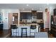 Granite kitchen island with stainless steel appliances and dark cabinetry at 129 Warbler Way, Mcdonough, GA 30253