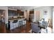 Modern kitchen with granite island, stainless steel appliances, and dark cabinetry at 129 Warbler Way, Mcdonough, GA 30253