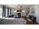 Open concept living room with a fireplace and hardwood floors at 129 Warbler Way, Mcdonough, GA 30253