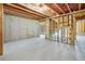 Spacious unfinished basement with concrete floor, exposed wood frame walls and ceiling insulation at 31 Bennett Farm Dr, Loganville, GA 30052