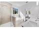Bright bathroom featuring a separate shower, soaking tub, and dual sink vanity at 31 Bennett Farm Dr, Loganville, GA 30052