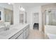 Bright bathroom featuring a separate shower, dual sink vanity, and walk-in closet at 31 Bennett Farm Dr, Loganville, GA 30052