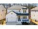 Charming two-story home with white painted brick, covered porch, and an attached two-car garage at 31 Bennett Farm Dr, Loganville, GA 30052