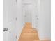Hallway with light hardwood floors, white walls and trim, and doors leading to rooms at 31 Bennett Farm Dr, Loganville, GA 30052