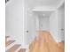 Hallway with gleaming hardwood flooring, bright lighting, and seamless transition to other rooms at 31 Bennett Farm Dr, Loganville, GA 30052
