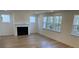 Spacious living room with hardwood floors, a fireplace, and large windows at 31 Bennett Farm Dr, Loganville, GA 30052