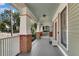 Large front porch with brick columns and white railings at 72 Waddell Ne St, Atlanta, GA 30307