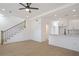 Open concept living area with kitchen, hardwood floors, and staircase at 2414 Rose Palm Pl, Atlanta, GA 30315