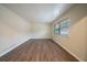Spacious living room with large windows and wood-look floors at 2476 Brentford Pl, Decatur, GA 30032