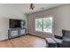 Bright bedroom featuring hardwood floors, large window, and comfortable seating at 4860 Boulder Stone Way, Auburn, GA 30011