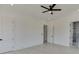 Bright bedroom with wood floors, ceiling fan, and access to a private bathroom at 553 Versailles Dr, Auburn, GA 30011