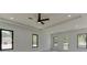 Bright bedroom with wood floors, multiple windows, and a ceiling fan at 553 Versailles Dr, Auburn, GA 30011