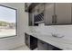 Butler's pantry with dark cabinetry, marble countertops, and wine rack at 553 Versailles Dr, Auburn, GA 30011
