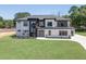 Modern two-story home with white brick and a landscaped lawn at 553 Versailles Dr, Auburn, GA 30011