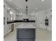 Modern kitchen boasts white cabinets, marble island, and a breakfast bar at 553 Versailles Dr, Auburn, GA 30011