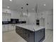 Modern kitchen boasts white cabinets, marble island, and a breakfast bar at 553 Versailles Dr, Auburn, GA 30011