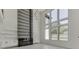 Living room with floor to ceiling windows and a modern fireplace at 553 Versailles Dr, Auburn, GA 30011