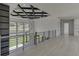Spacious loft overlooking backyard with hardwood floors and modern chandelier at 553 Versailles Dr, Auburn, GA 30011