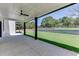 Covered patio with ceiling fan, overlooking a landscaped yard at 553 Versailles Dr, Auburn, GA 30011