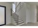 Modern staircase with sleek metal railing and light wood steps at 553 Versailles Dr, Auburn, GA 30011