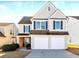 Two-story house with beige siding, two-car garage, and manicured lawn at 2350 Ashton Dr, Roswell, GA 30076