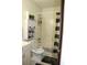 Bathroom featuring a tub with shower, neutral toilet, and a storage cabinet at 2805 Macon Se Dr # 26E, Atlanta, GA 30354