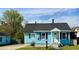 Charming blue single-story home with a well-maintained lawn and a classic black roof at 303 Latimer Se St, Marietta, GA 30008