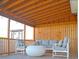 Relaxing patio with covered seating area, string lights, and wooden privacy wall at 303 Latimer Se St, Marietta, GA 30008