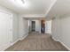 Unfinished basement area with carpet flooring, neutral walls, and storage space at 3670 Leisure Ln, Atlanta, GA 30349