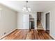 Dining room with hardwood floors, traditional chandelier, and access to the basement at 3670 Leisure Ln, Atlanta, GA 30349