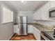Kitchen featuring stainless steel appliances, white cabinets, and granite countertops at 3670 Leisure Ln, Atlanta, GA 30349