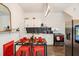 Updated kitchen with white cabinets, red accents, and a farmhouse table at 607 Gaskill Se St, Atlanta, GA 30316