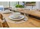 Simple dining area with a wooden table and place settings for two at 1625 Island Way, Buford, GA 30519