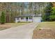 White house with blue door, porch, and attached garage; ample driveway parking at 1625 Island Way, Buford, GA 30519