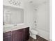 Bathroom with dark vanity, white toilet and bathtub at 1646 Larkspur Trl, Conyers, GA 30012